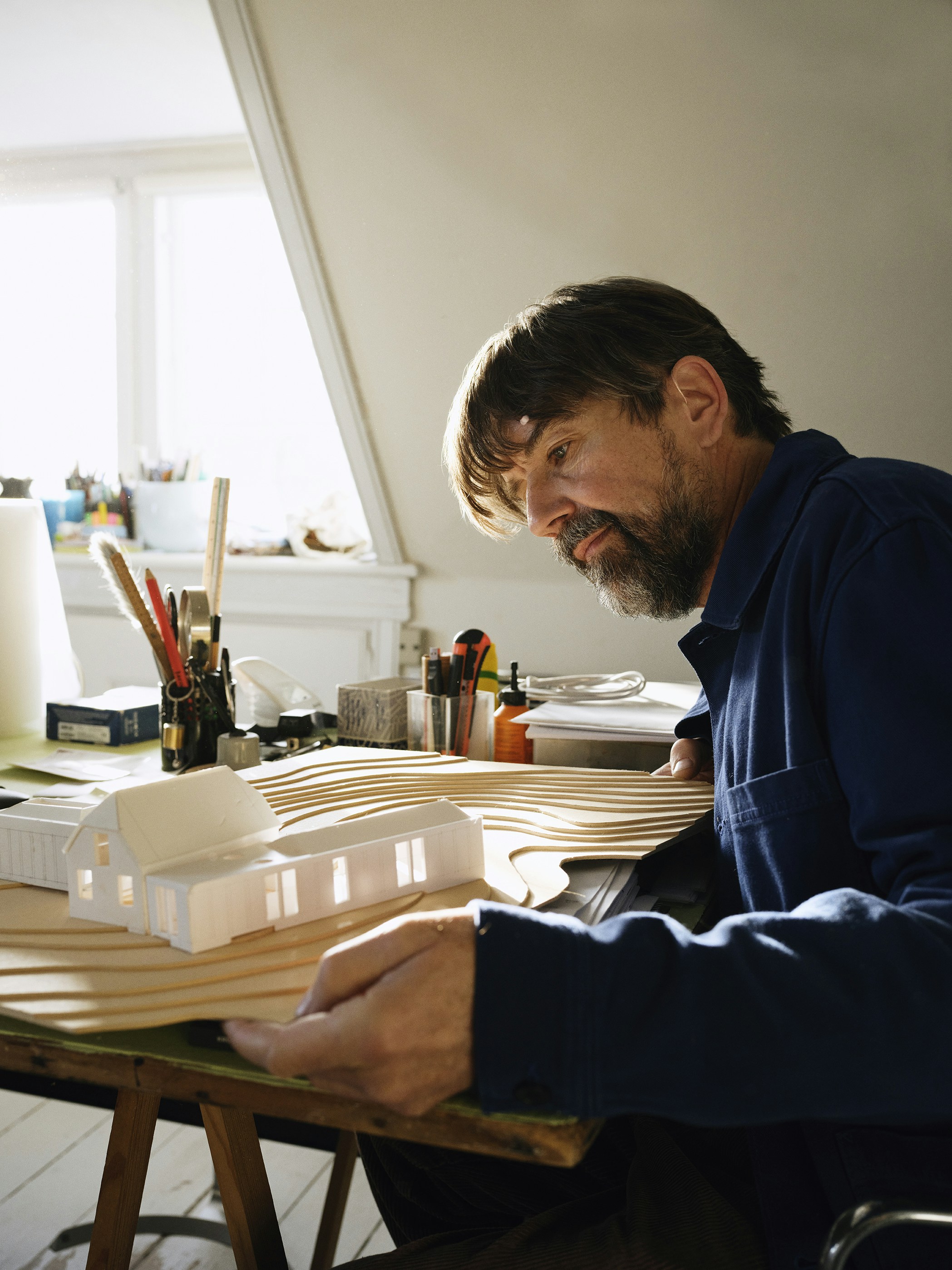 Man working on architectural model at desk