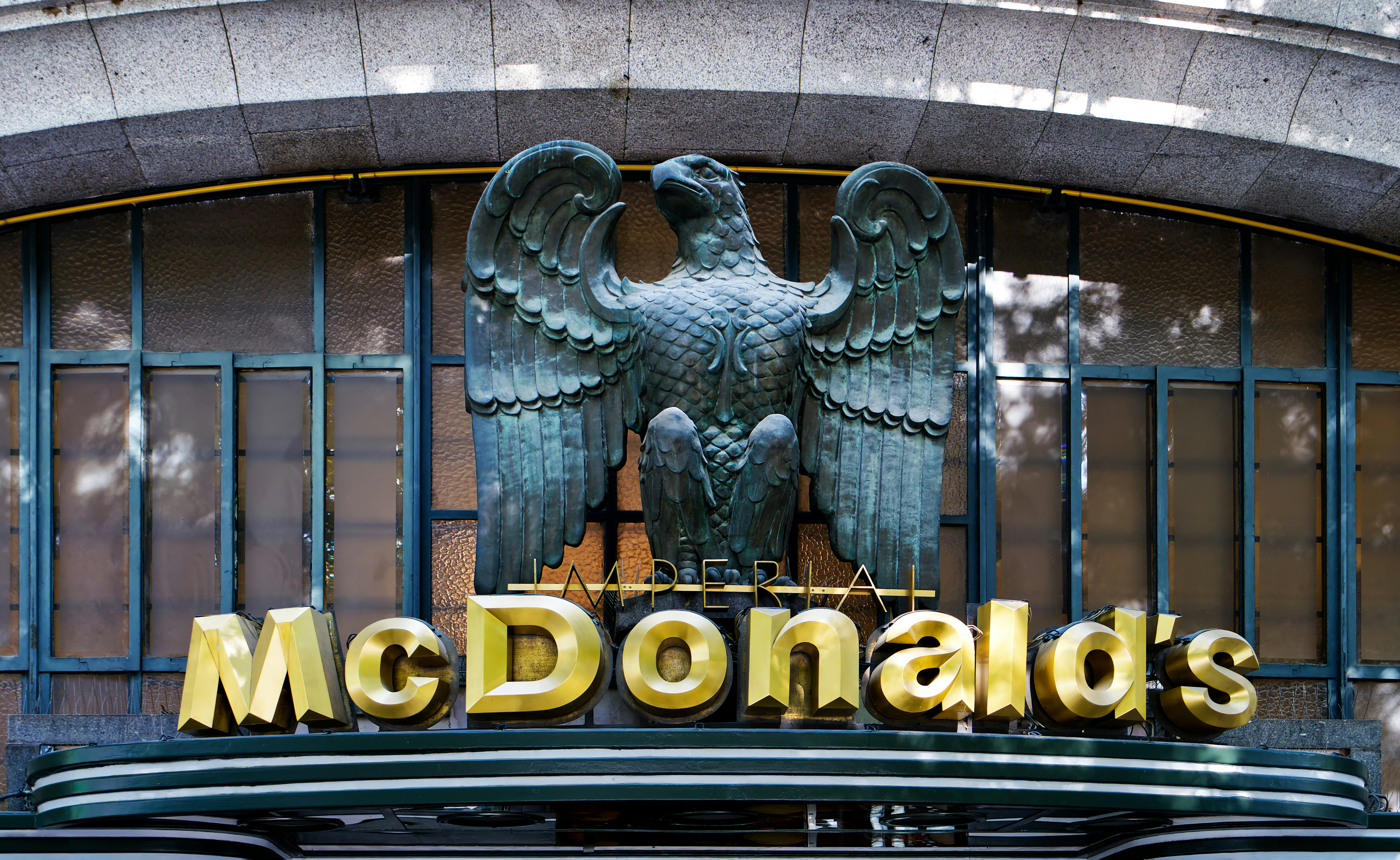 Mcdonald's sign with eagle sculpture above