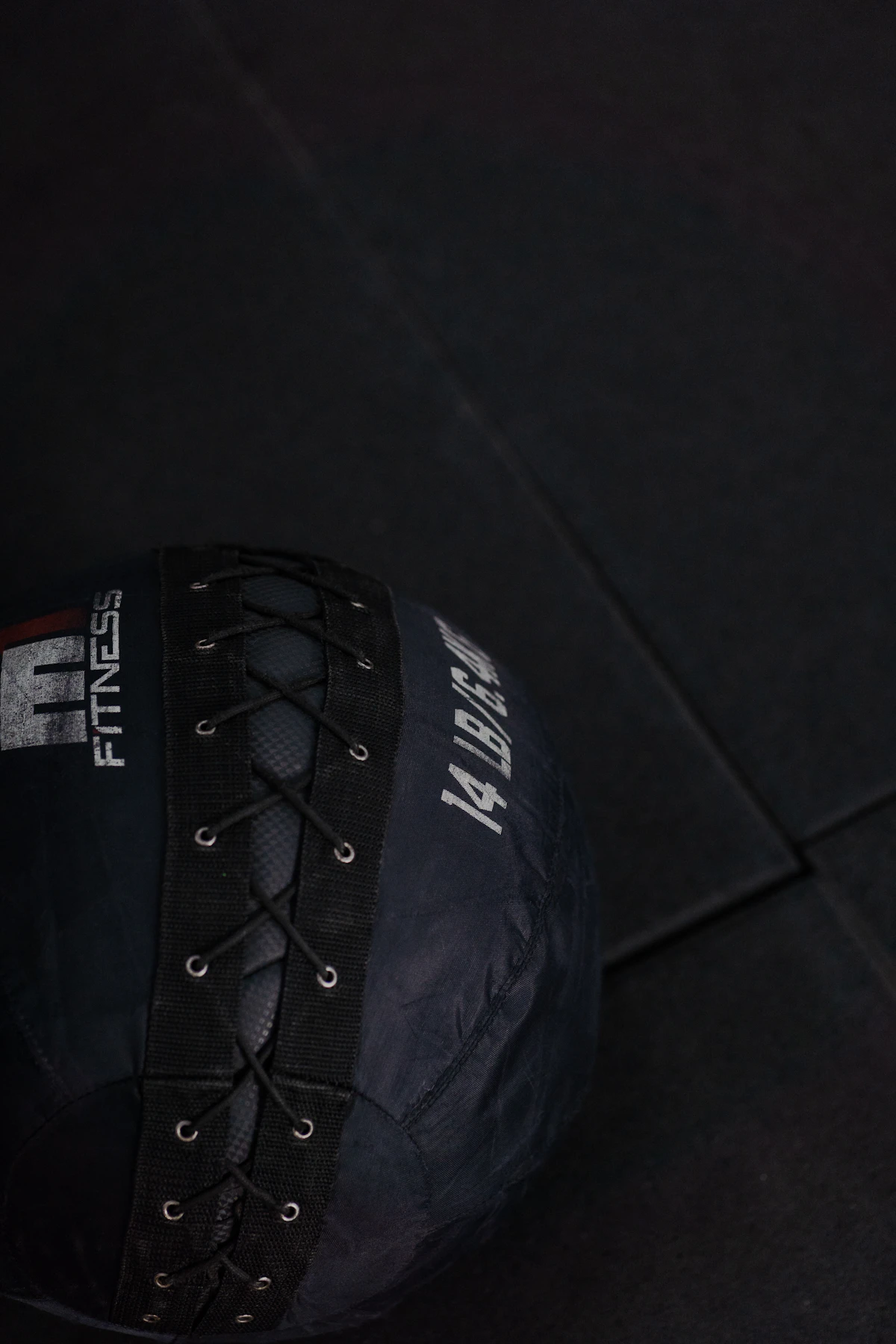 A blue medicine ball ready for wall ball training in the Hyrox arena
