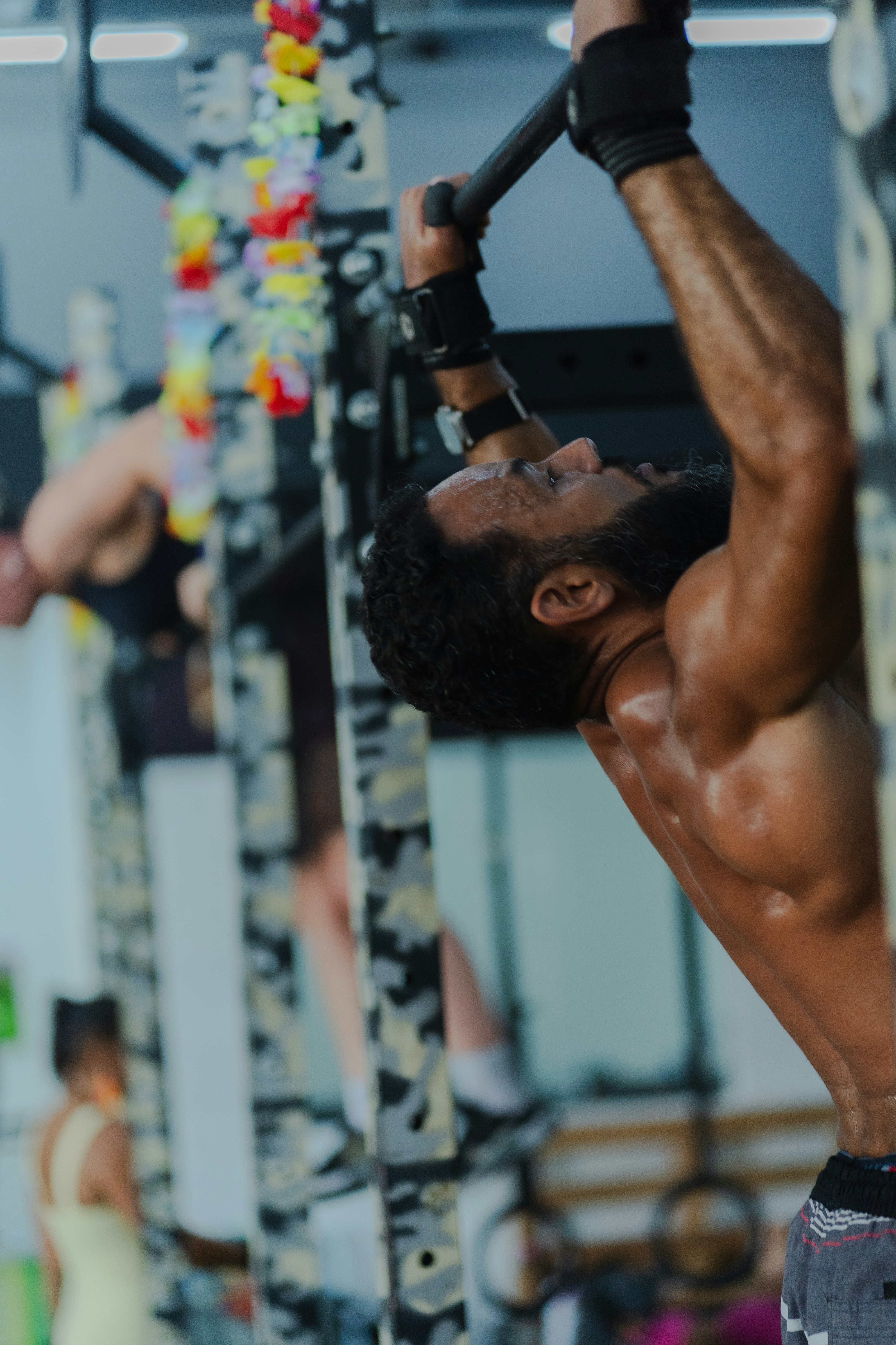 Man performing pull-ups at a gym