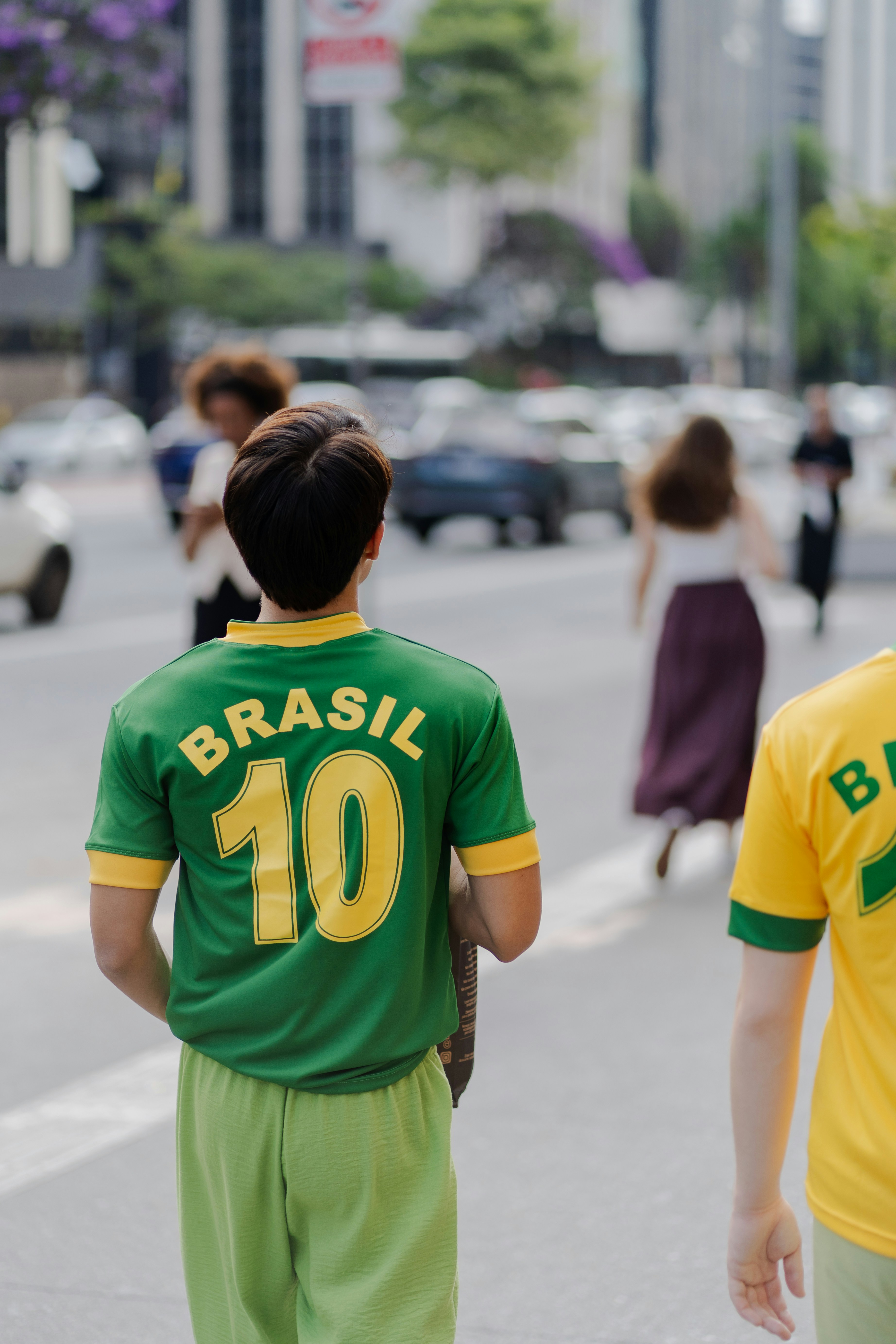 Man wearing a green brasil soccer jersey with number 10.
