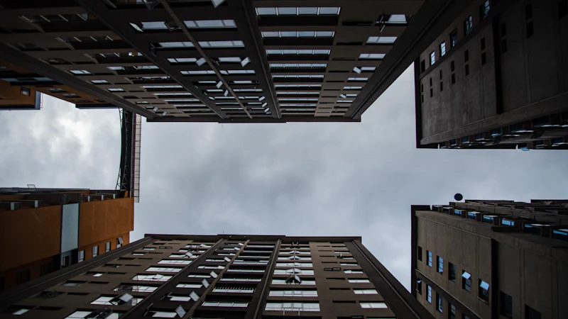 Looking up at tall apartment buildings against the sky