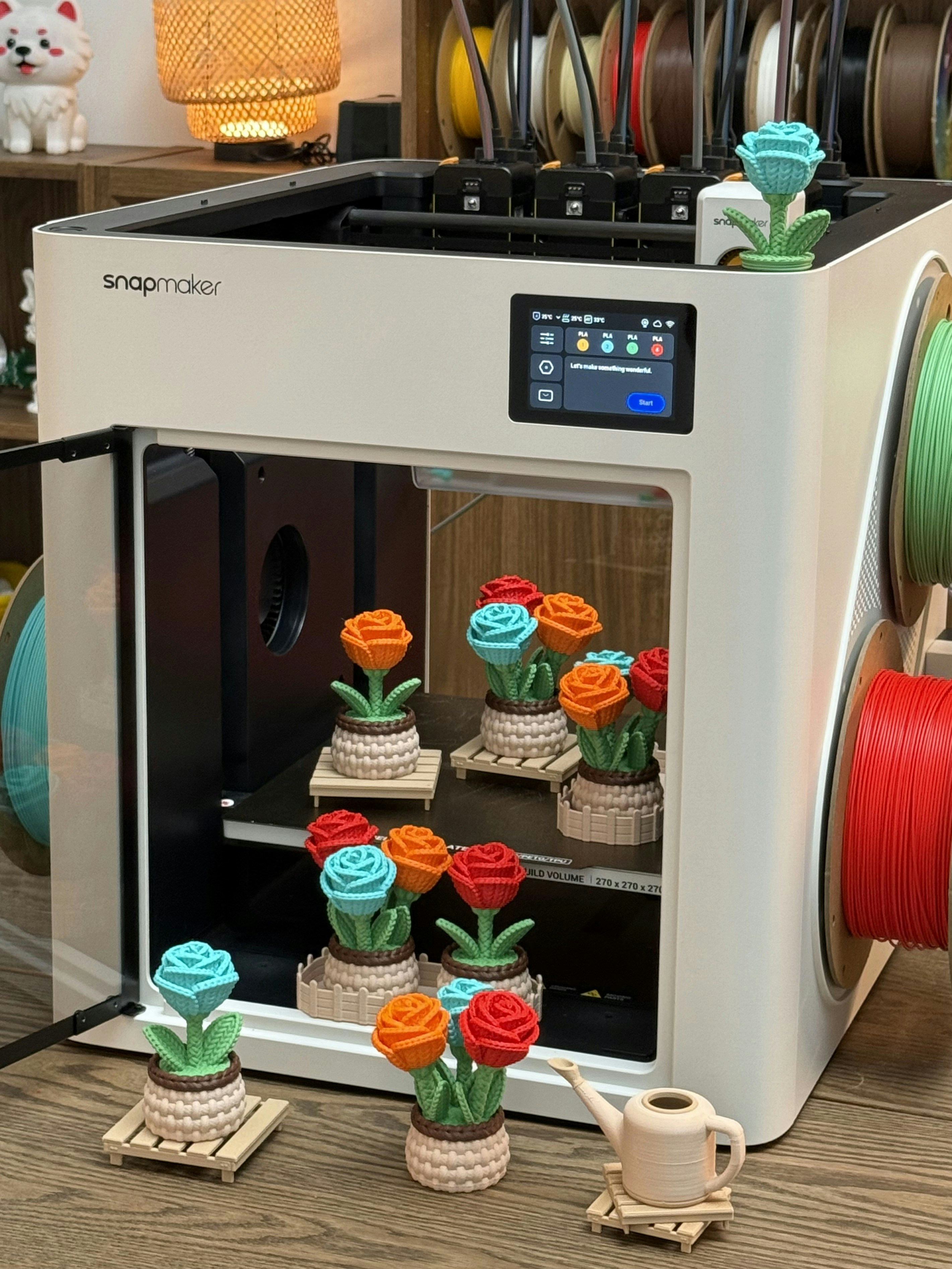 3D model by @flowercat. A portrait view of a Snapmaker 3D printer displaying colorful flower prints and multiple filament spools.