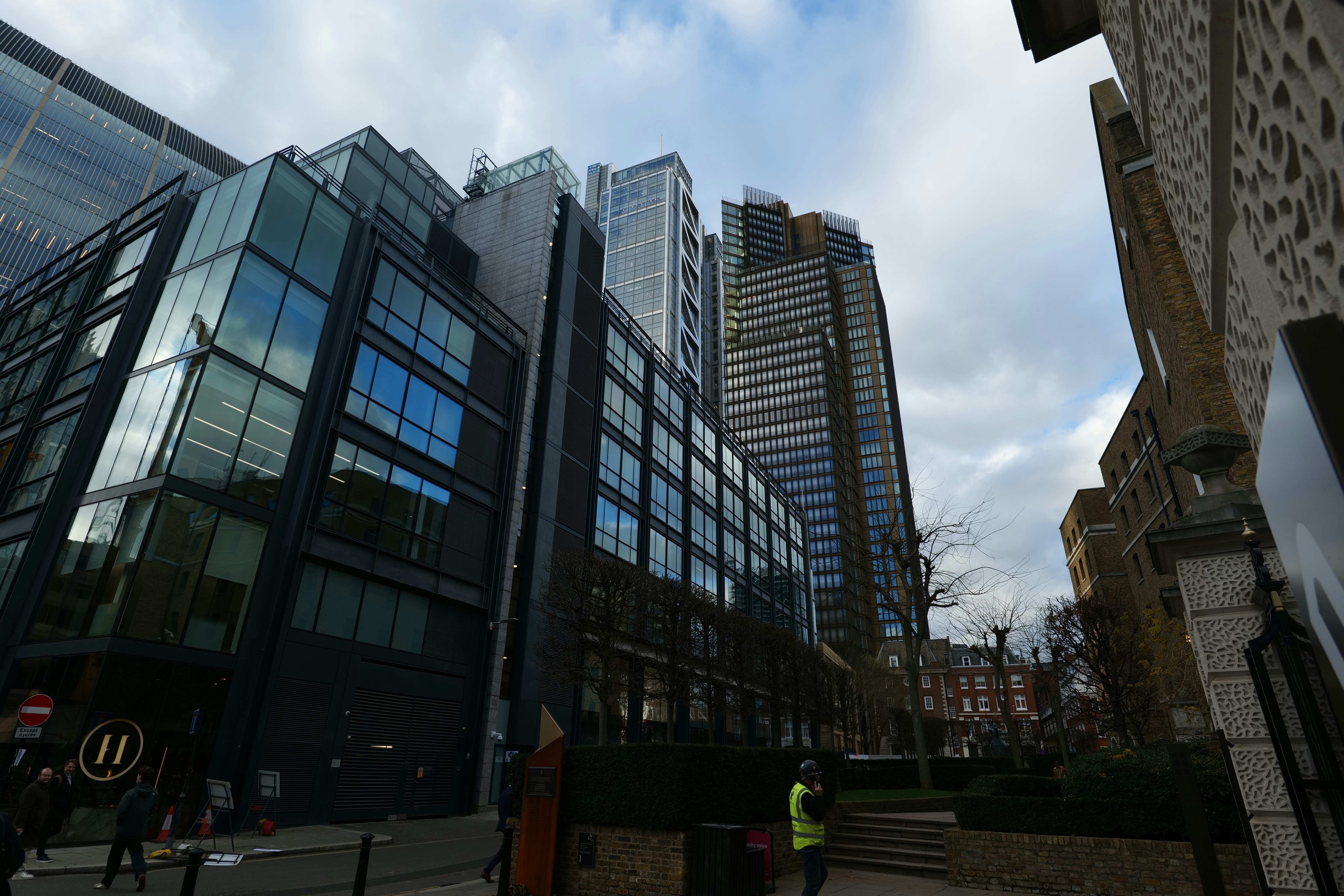 Modern glass buildings against a cloudy sky
