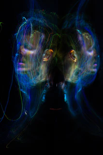 Abstract light painting of two mirrored faces