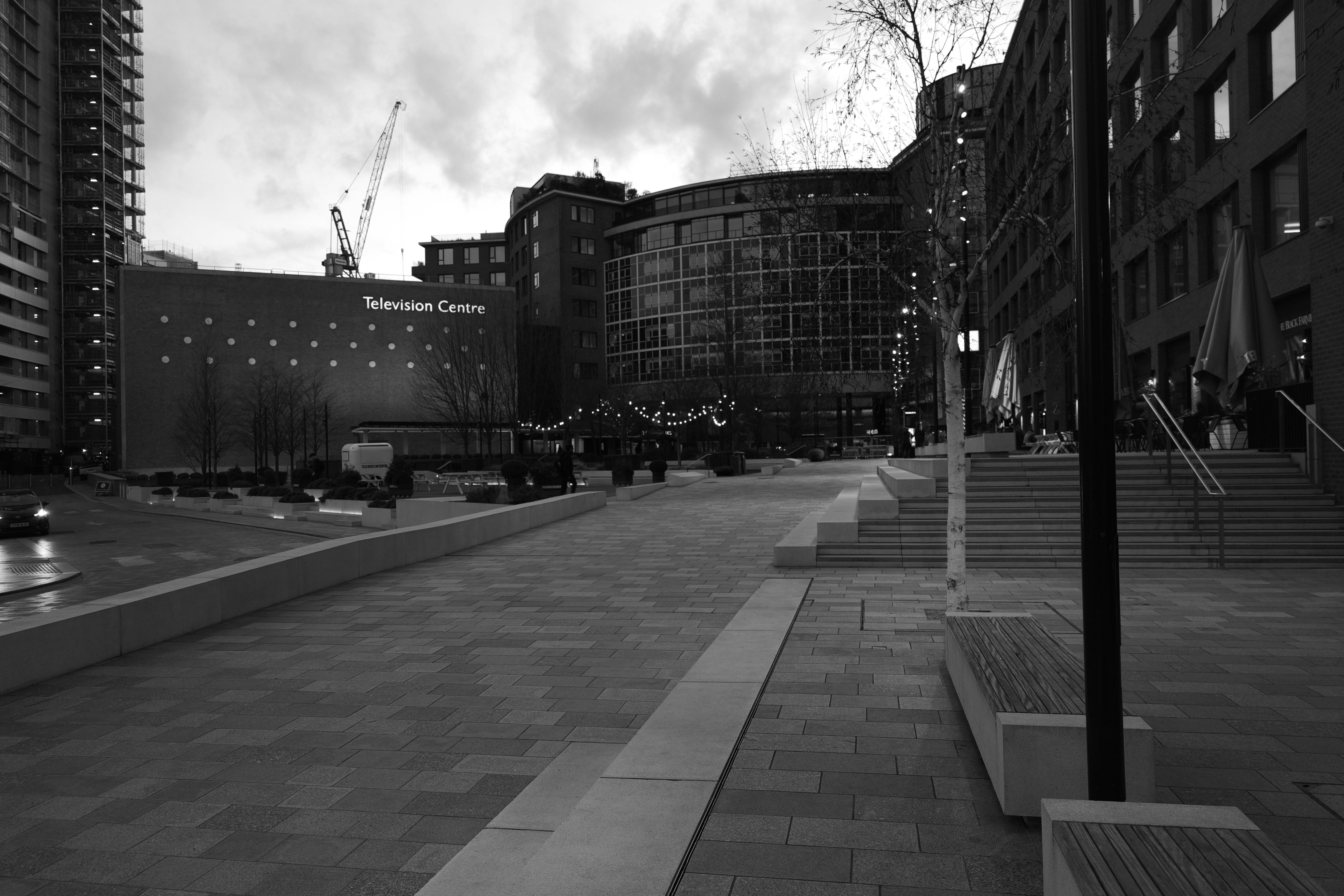 Modern buildings and plaza in black and white.