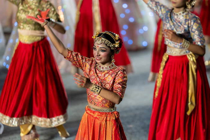 Girl dancing in traditional mirrored Indian attire during a Garba celebration