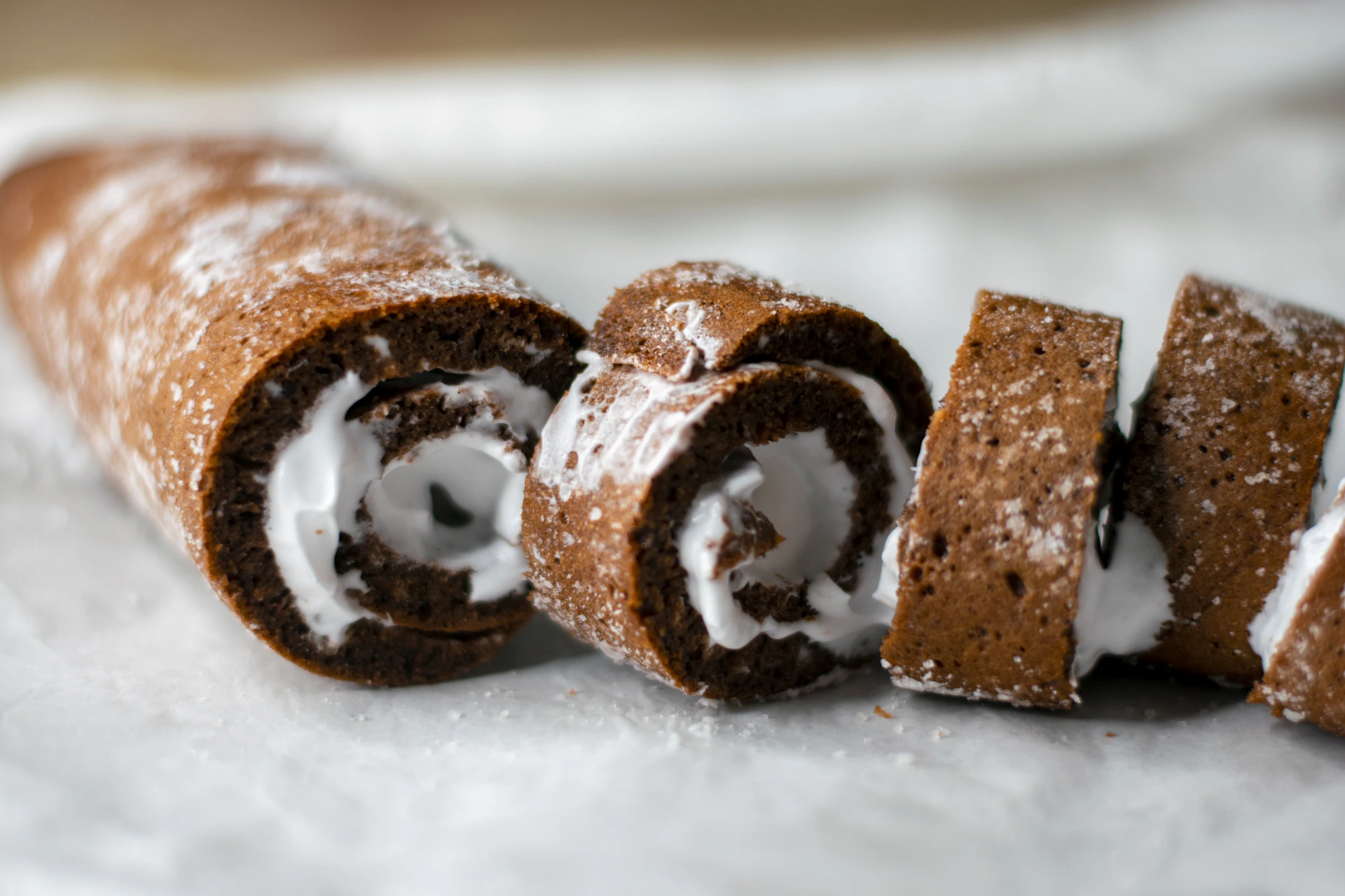 Chocolate swiss roll cake with white cream filling