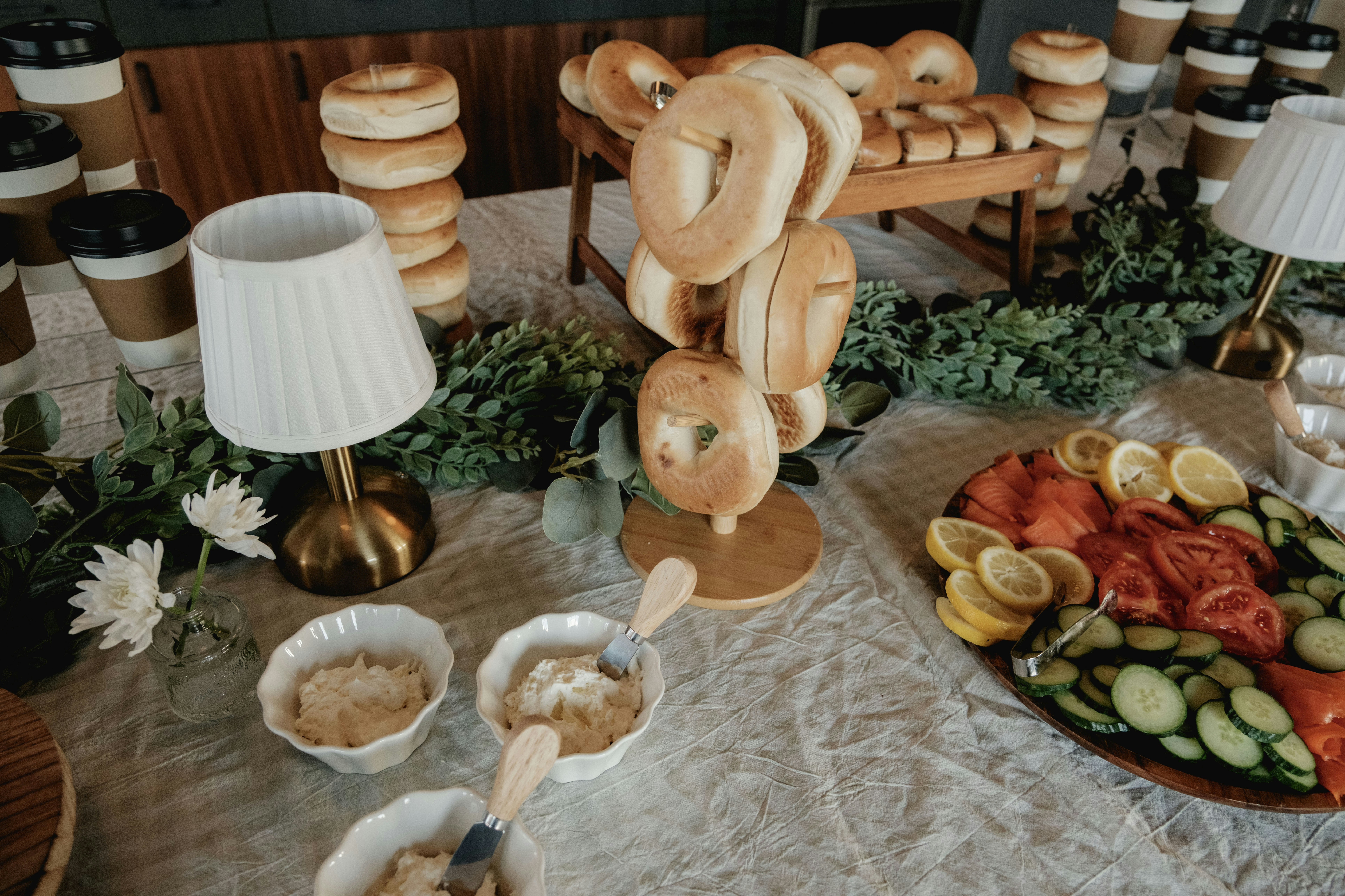 Bagel spread with cream cheese, fruit, and vegetables.