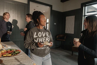 People socializing and enjoying snacks at a gathering.