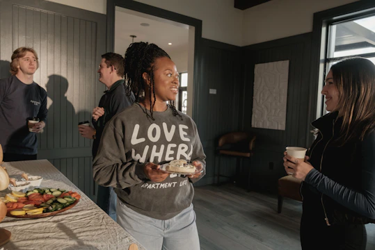 People socializing and enjoying snacks at a gathering.