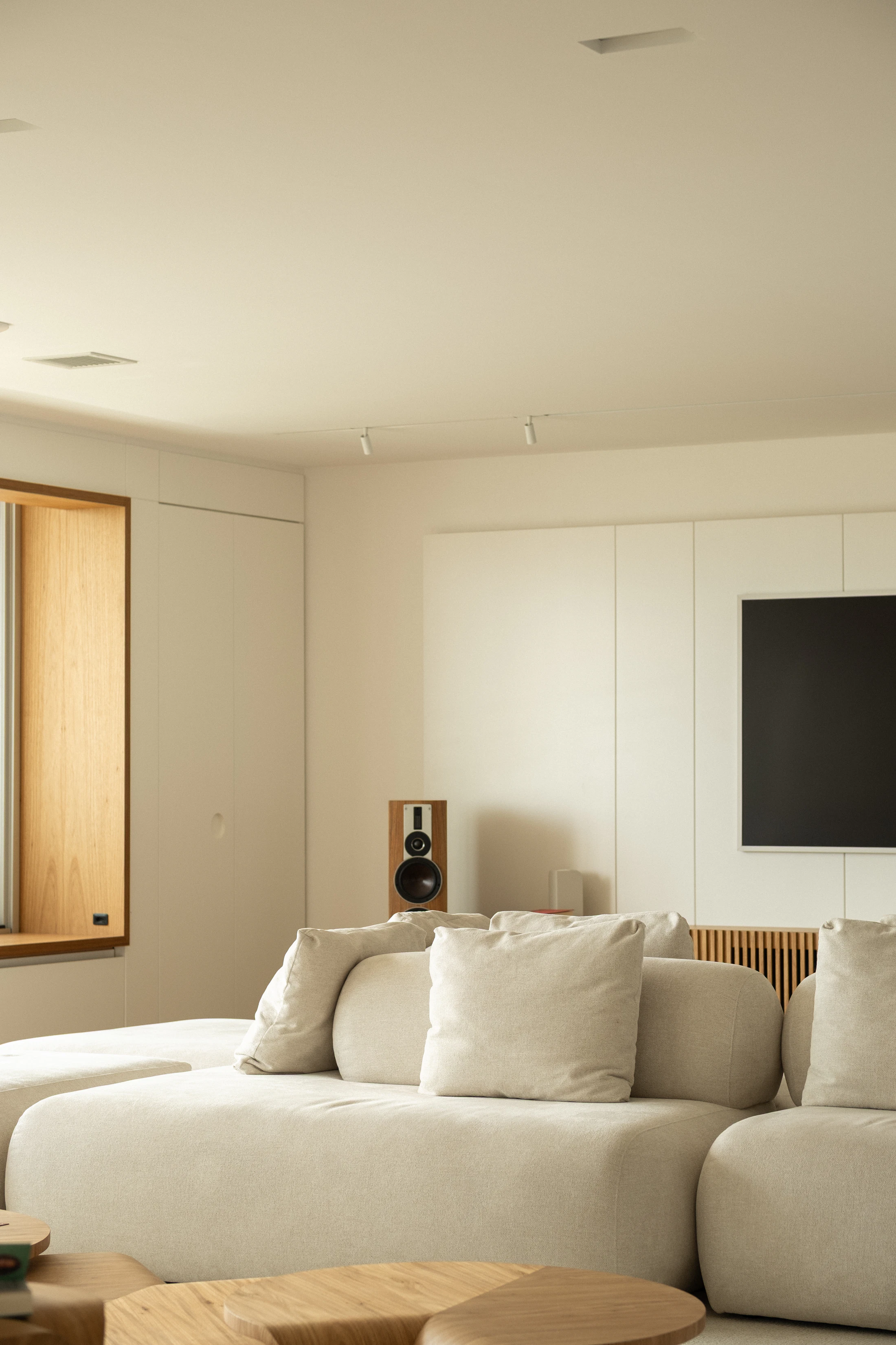 Modern warm living room with sectional sofa and natural wood furniture