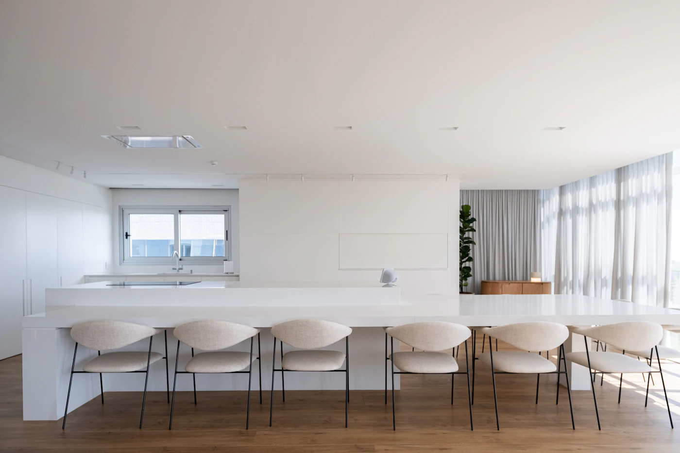 Bright white kitchen with an island and chairs