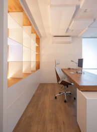 Modern office with wooden desk and shelves