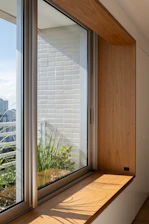 Wooden window seat with plants and city view