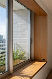 Wooden window seat with plants and city view