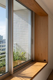 Wooden window seat with plants and city view