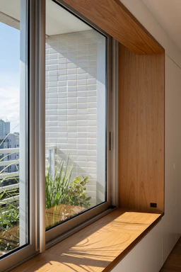 Wooden window seat with plants and city view