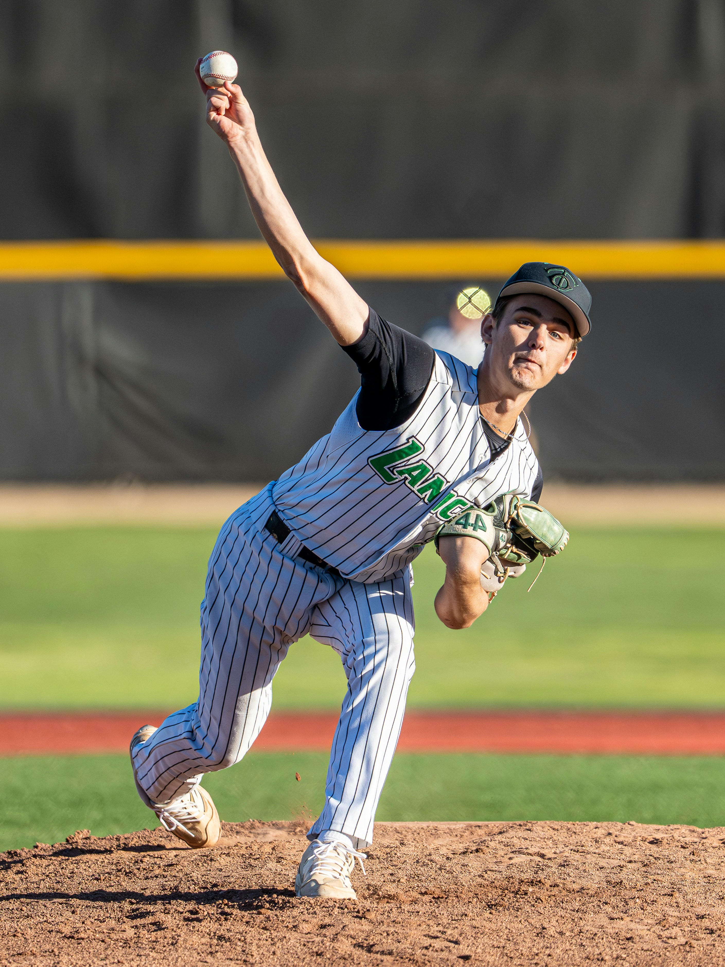 A baseball pitcher throwing a ball during a game.