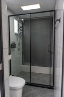 Modern bathroom with glass shower and toilet