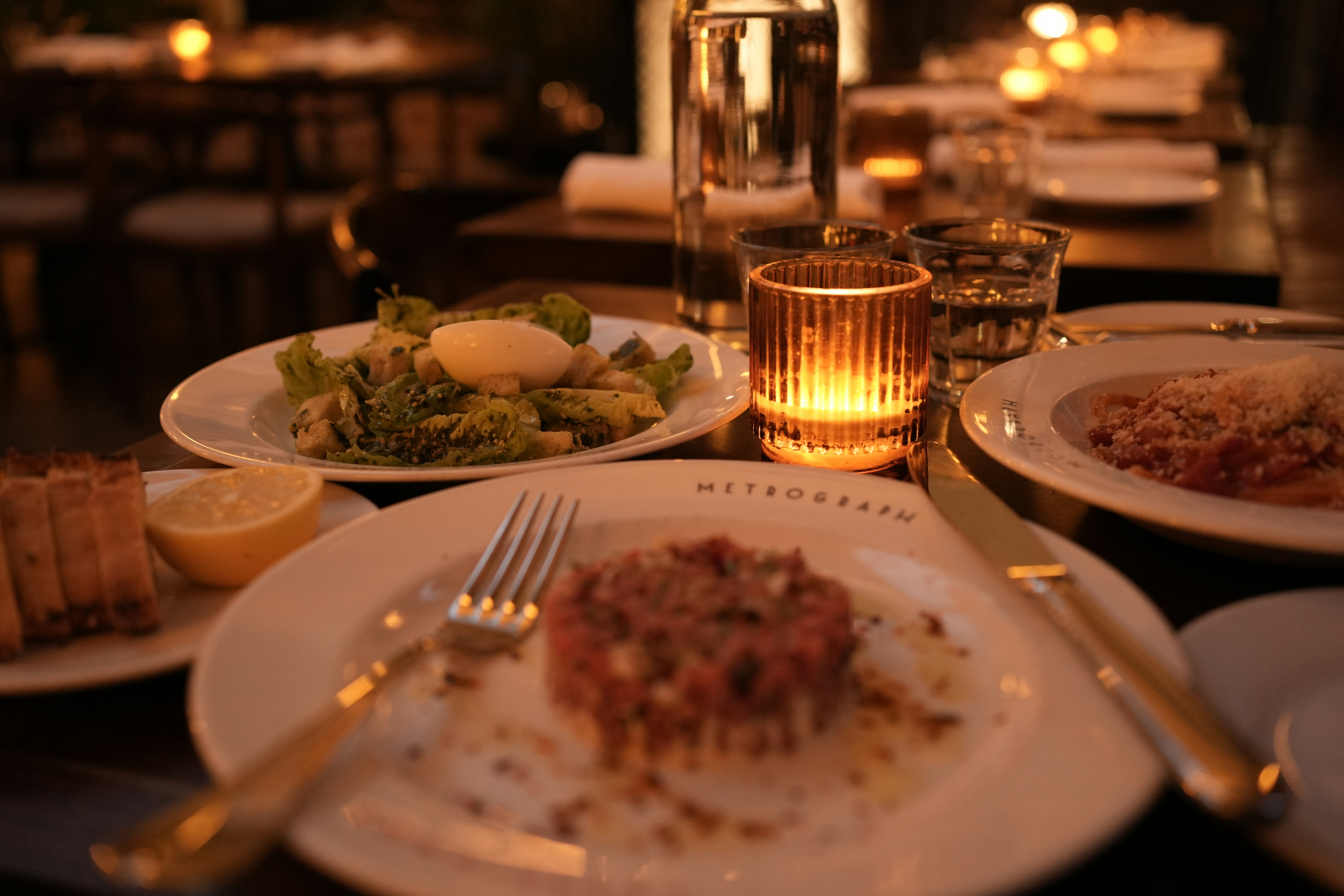 A romantic dinner setting with food and candles