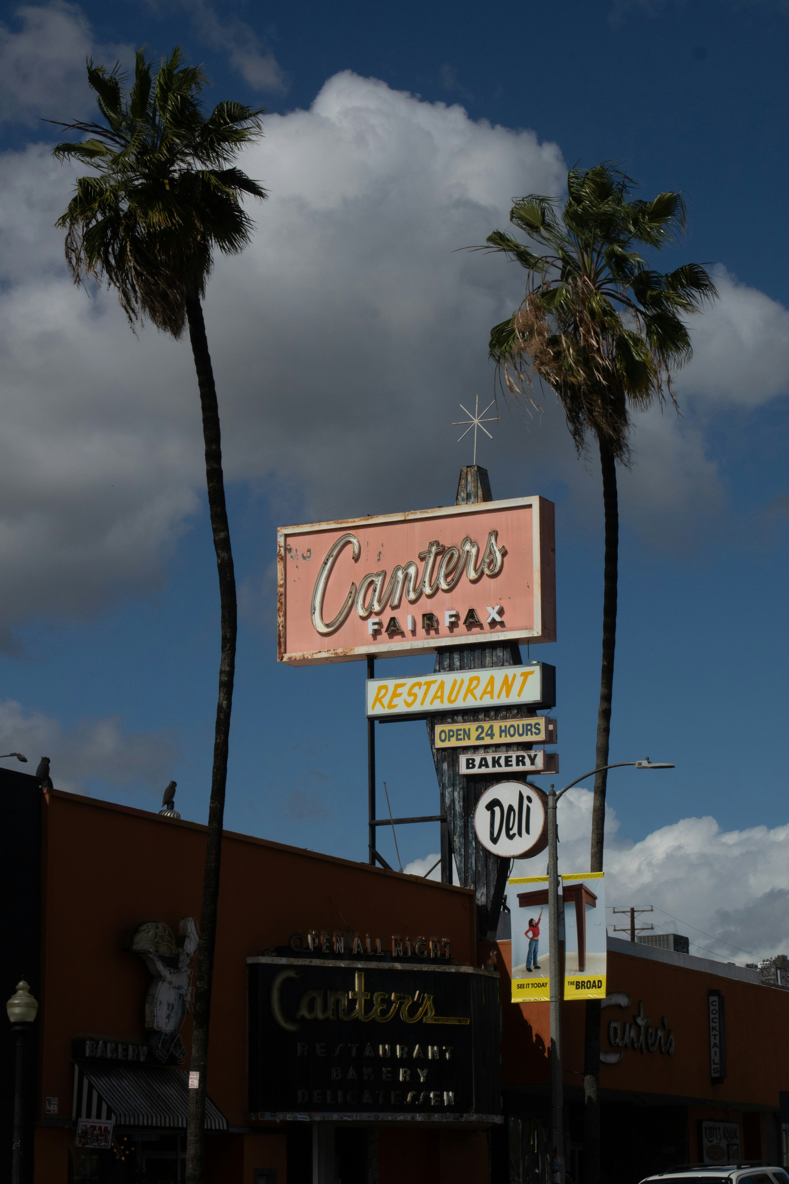 Canters restaurant sign with palm trees against sky