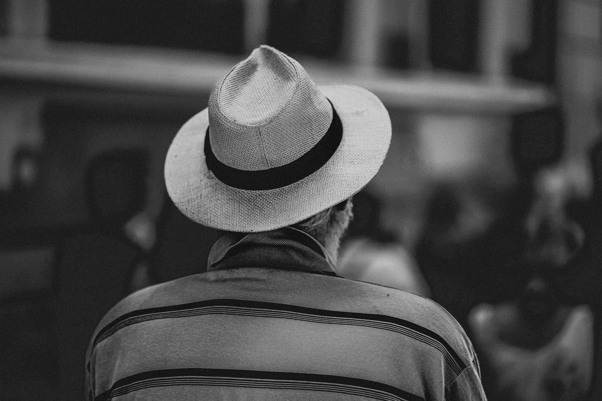 Man wearing a fedora hat and striped shirt