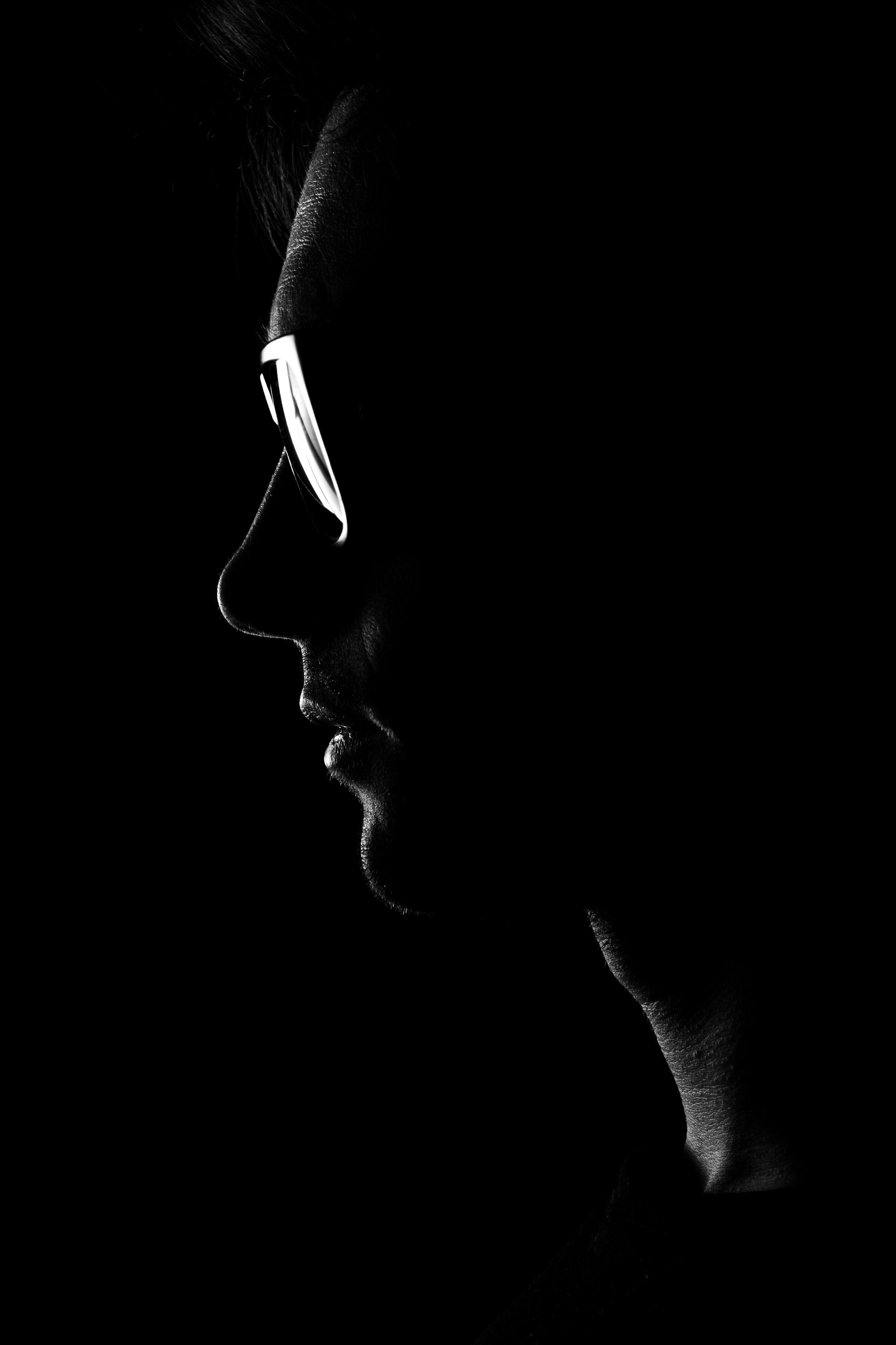 Profile of a person wearing glasses in silhouette