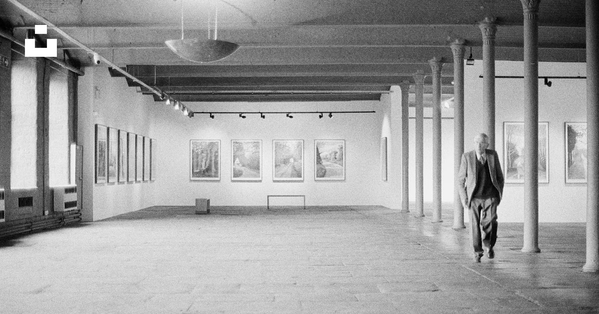 Man walking through a large, empty art gallery photo – Free ...