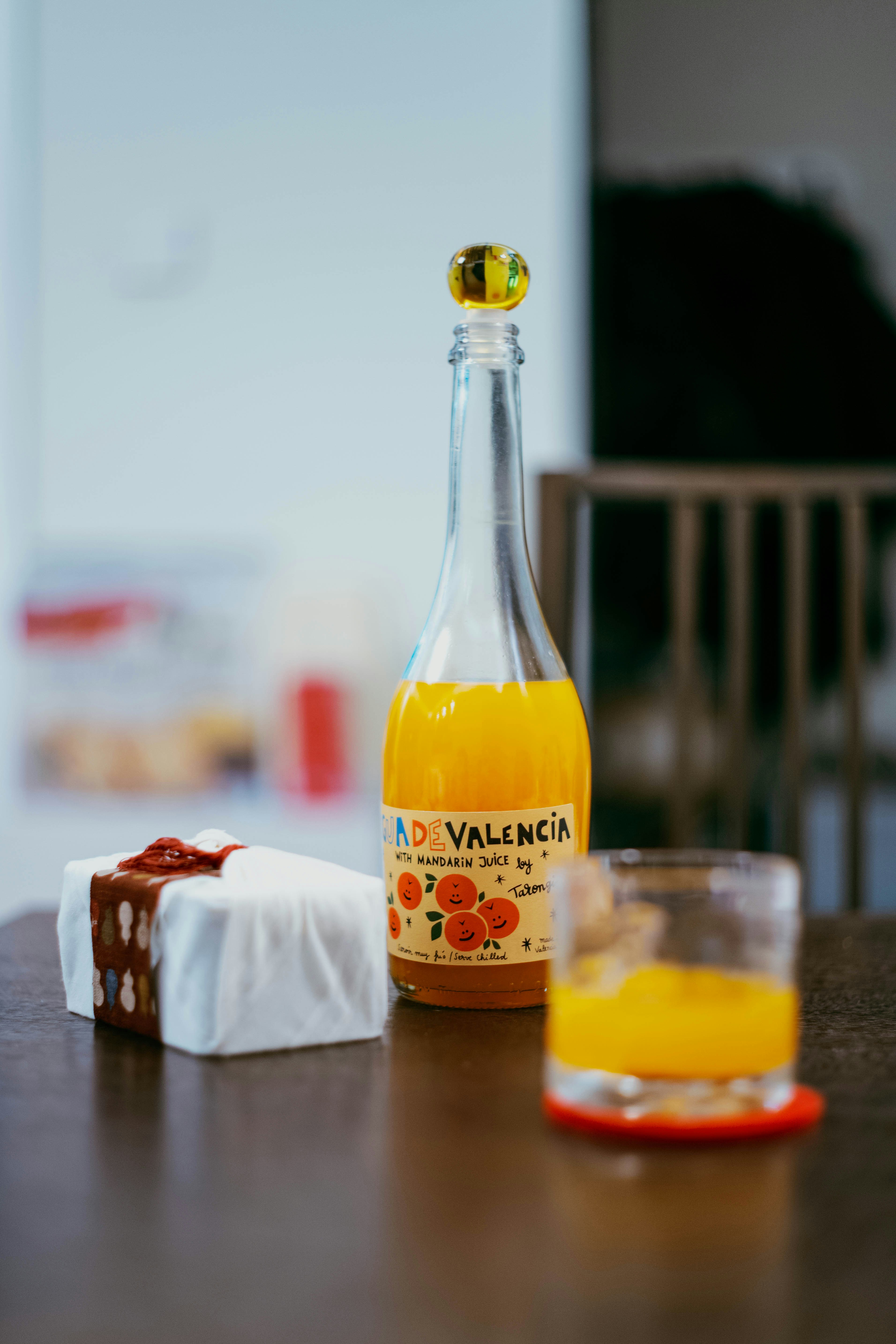 Bouteille de jus d’orange et cadeau sur la table