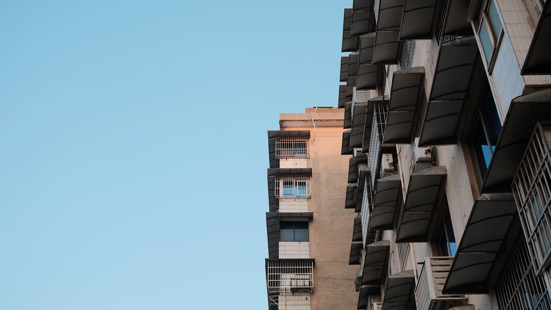 Modern apartment buildings against a clear blue sky