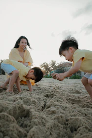 Mother and sons playing on a sandy beach