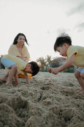 Mother and sons playing on a sandy beach