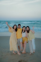 A family poses for a photo on the beach.
