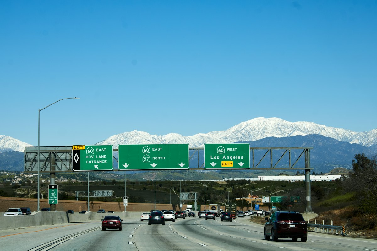 A freeway with snow-capped mountains in the distance