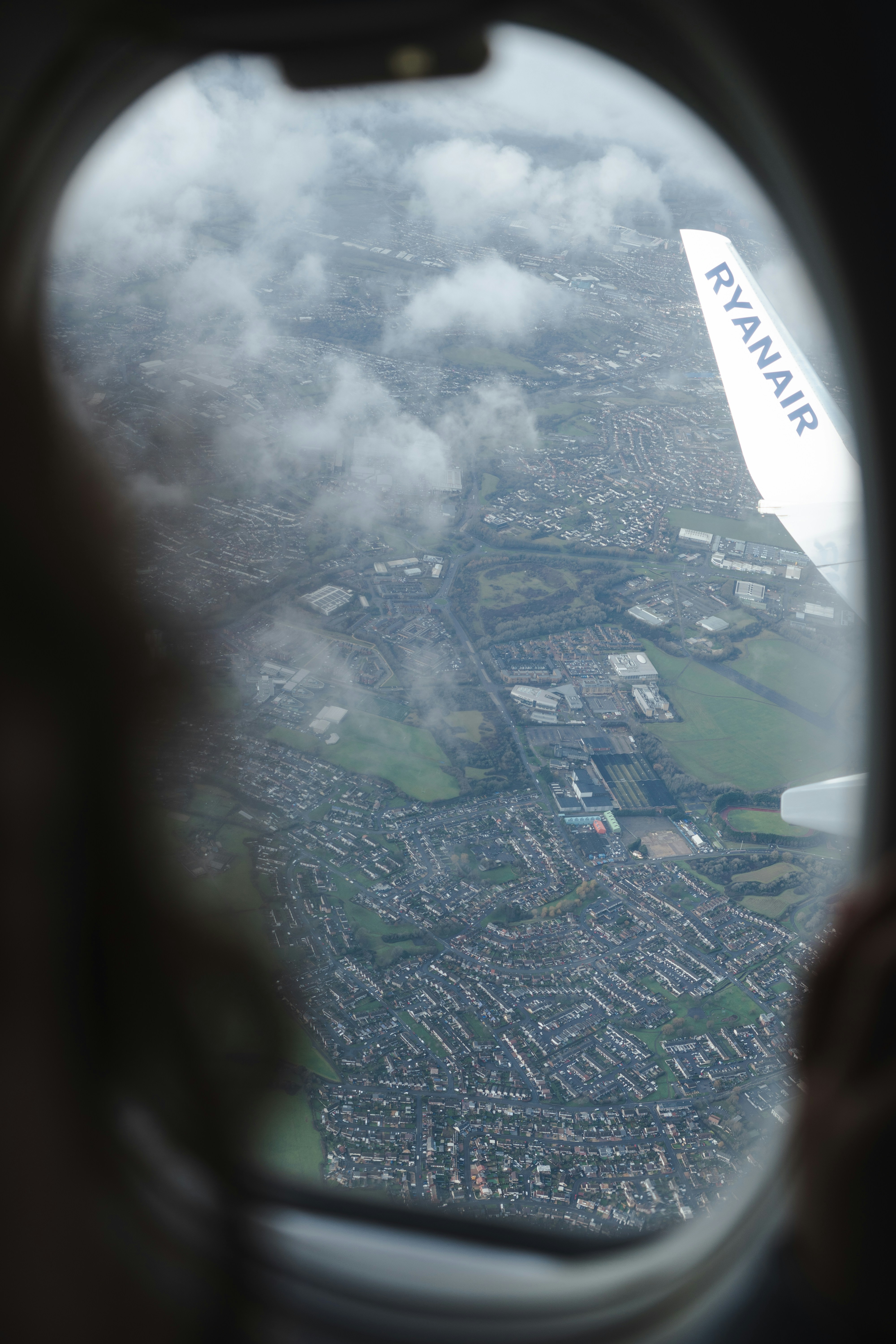 View of town from airplane window with wing