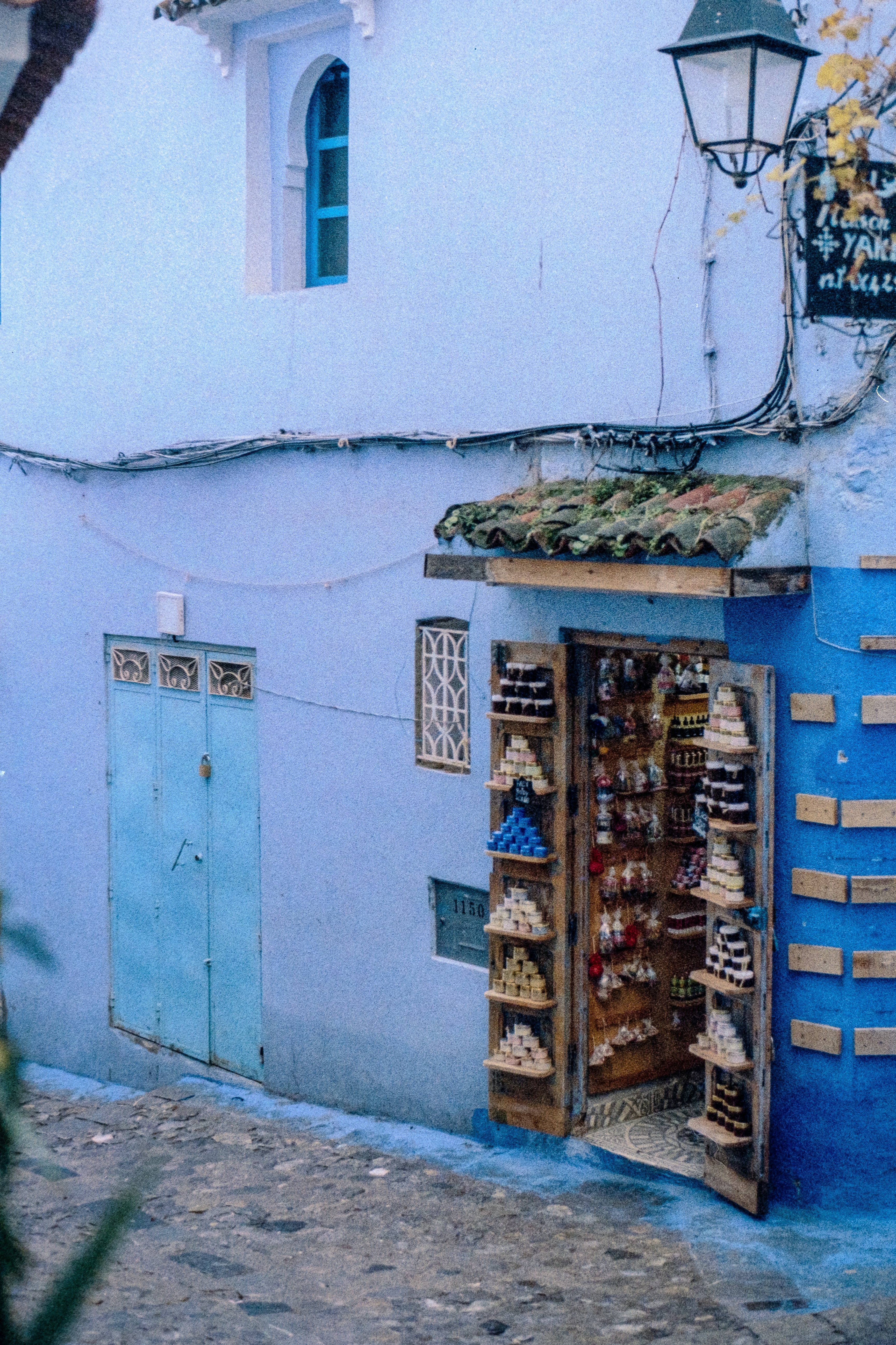 Blue building with a shop displaying goods