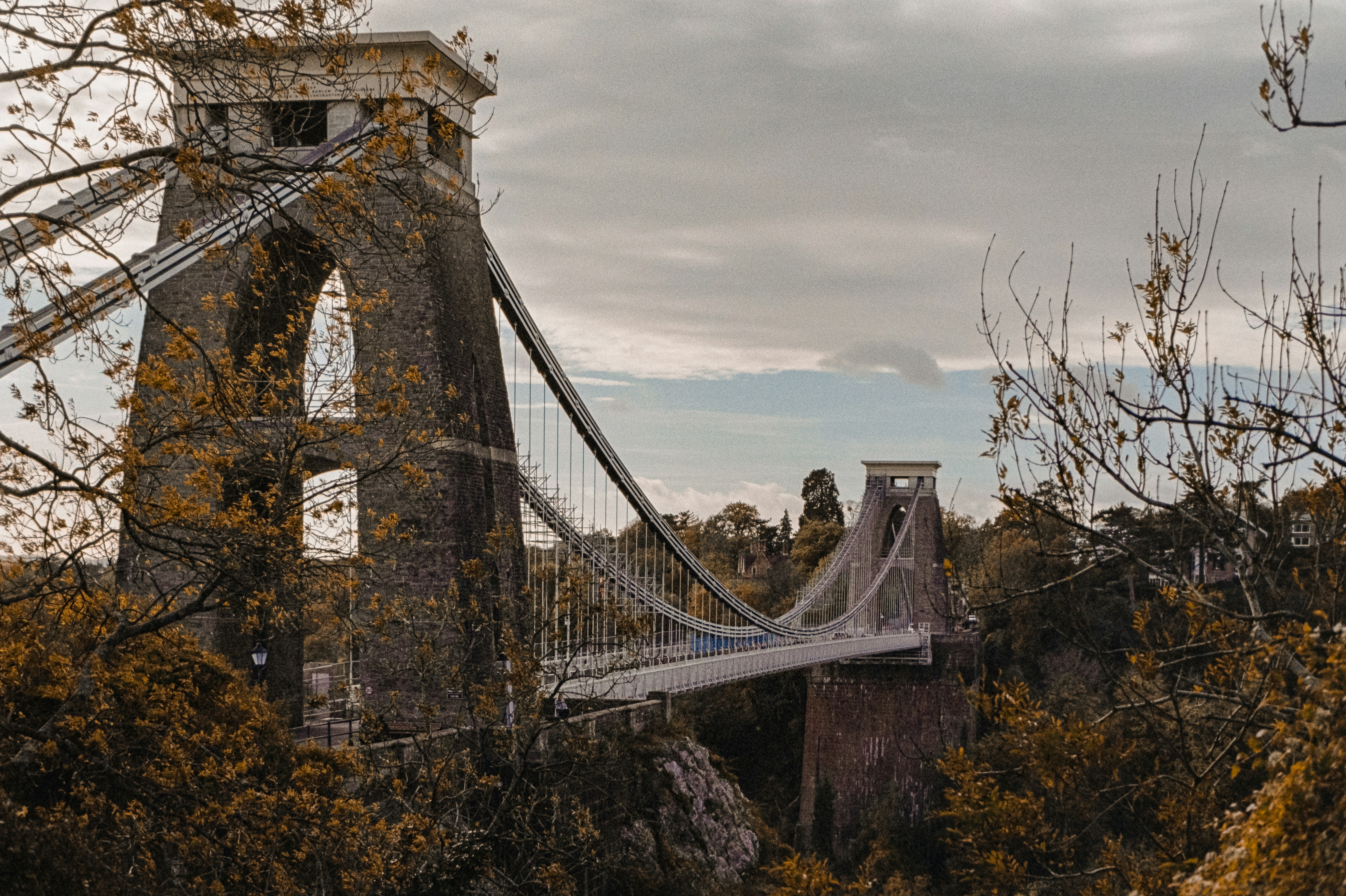 Historic suspension bridge surrounded by autumn foliage