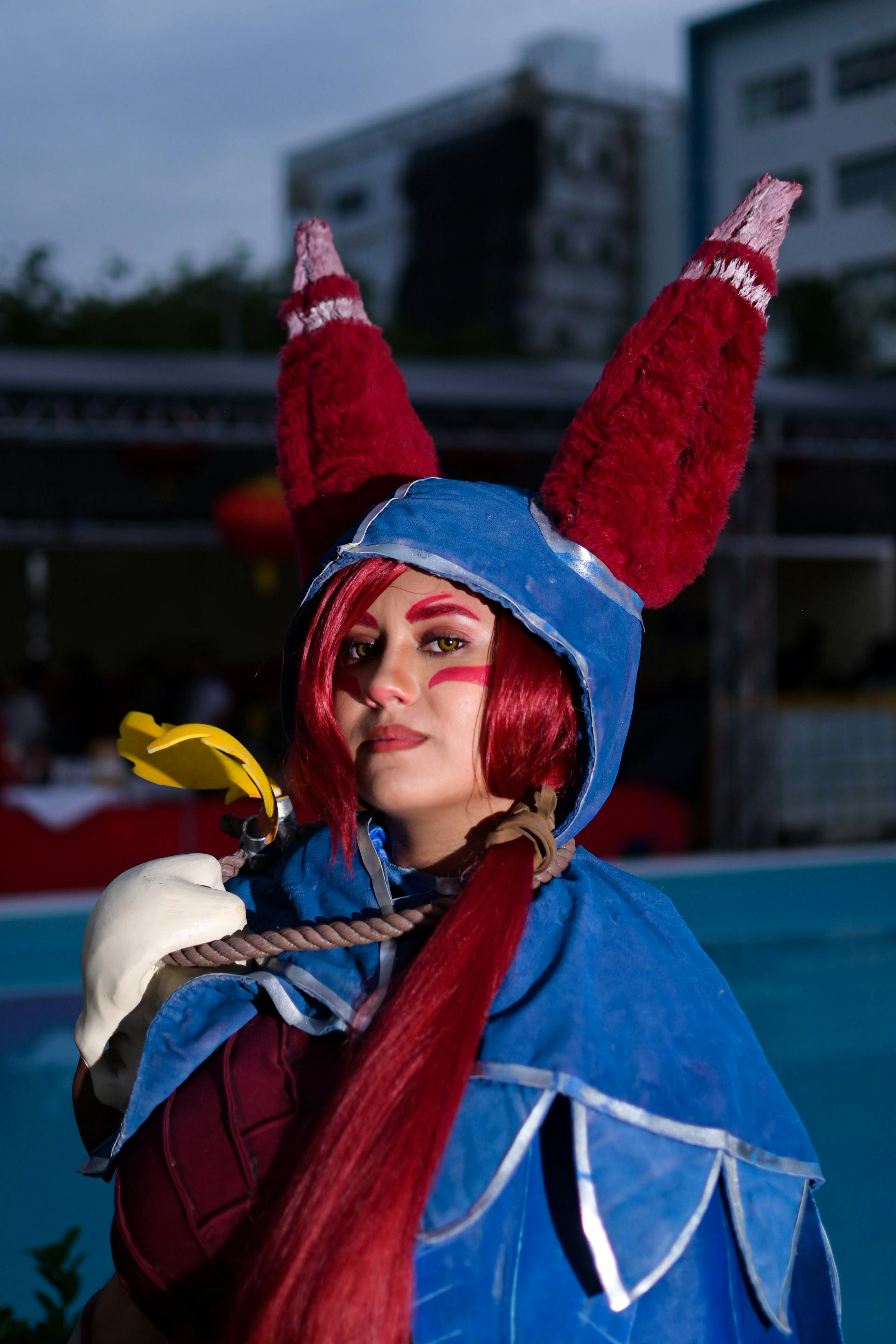 Wanita berkostum biru dan merah dengan telinga merah besar