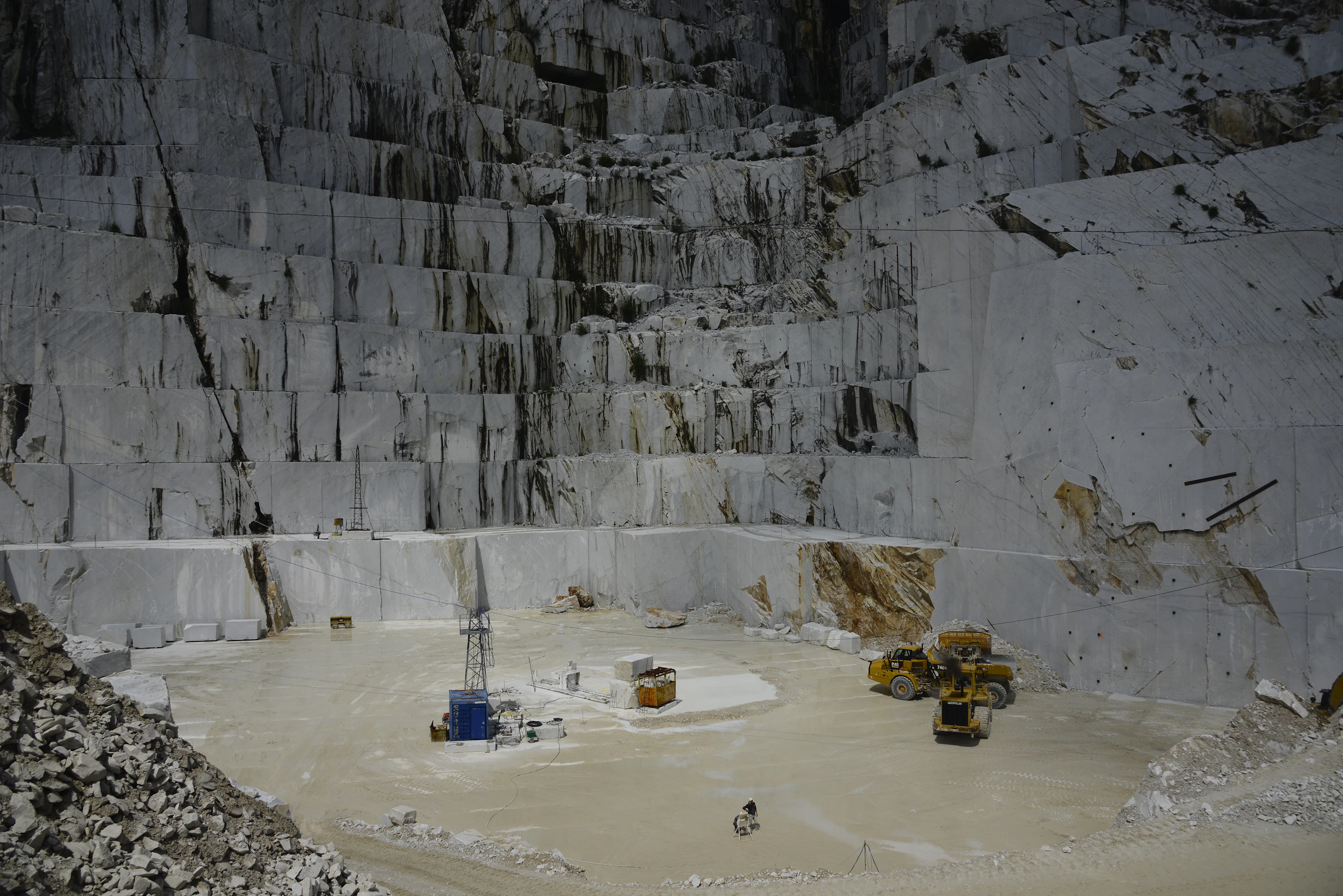 Marble quarry with heavy machinery and workers