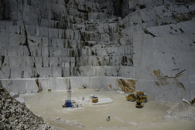 Marble quarry with heavy machinery and workers