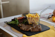 Grilled steak with french fries and salad