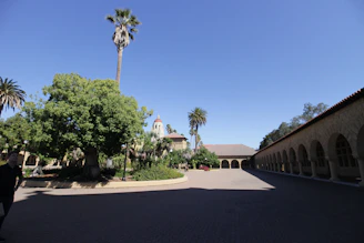 Courtyard with arched walkway and palm trees