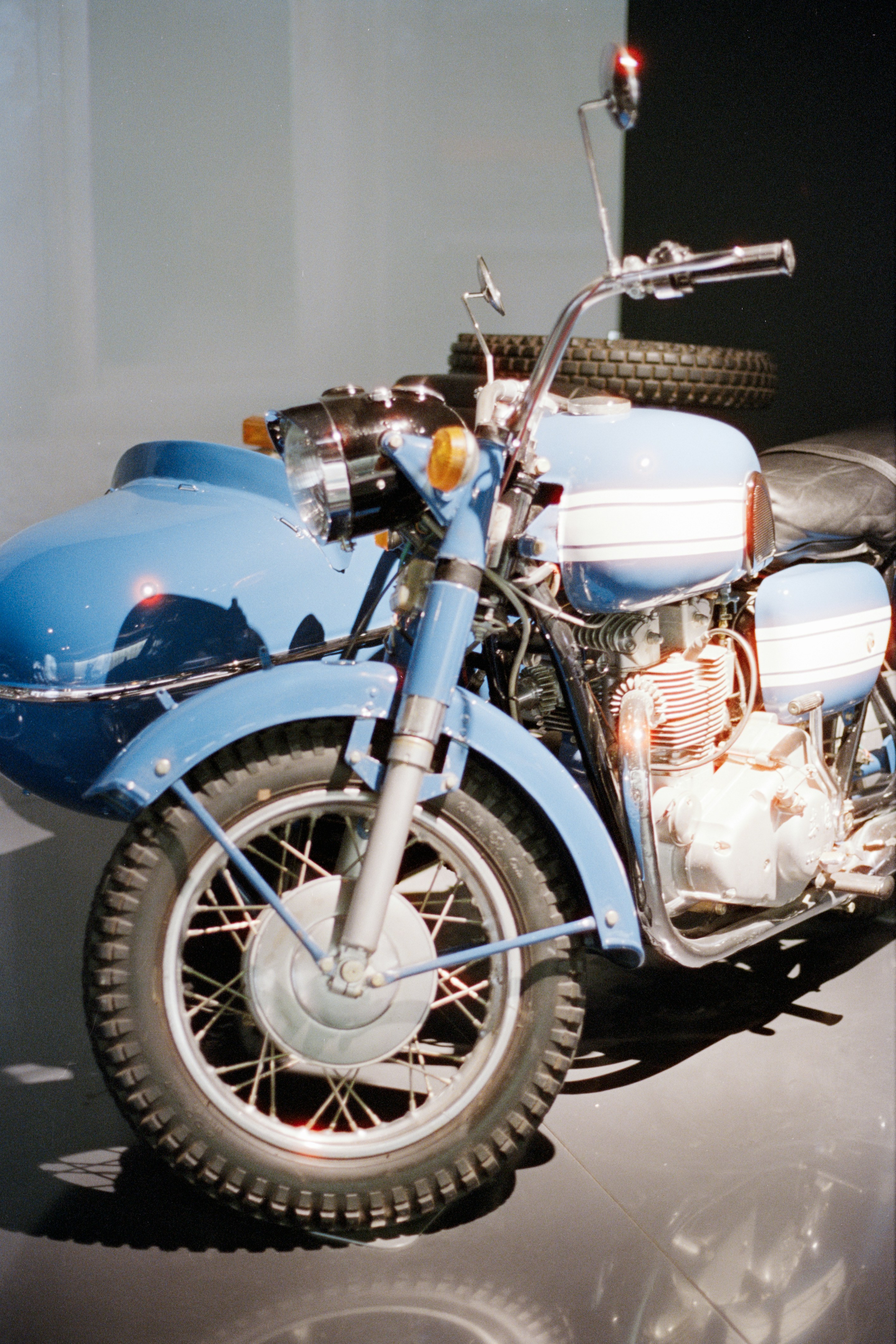 A vintage blue motorcycle with a sidecar