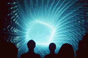Silhouettes of people watching a bright blue swirling vortex
