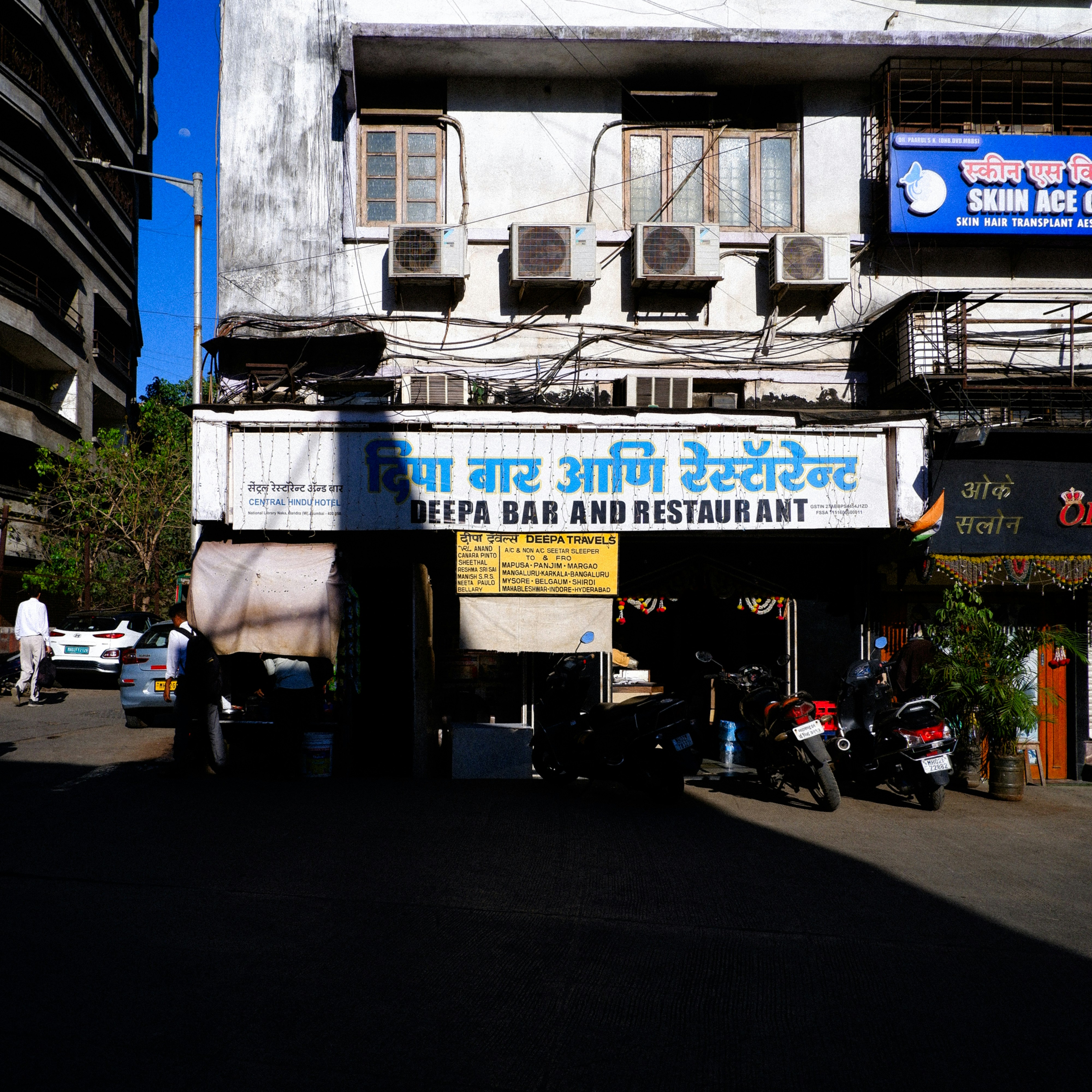 A storefront for deepa bar and restaurant on a street.