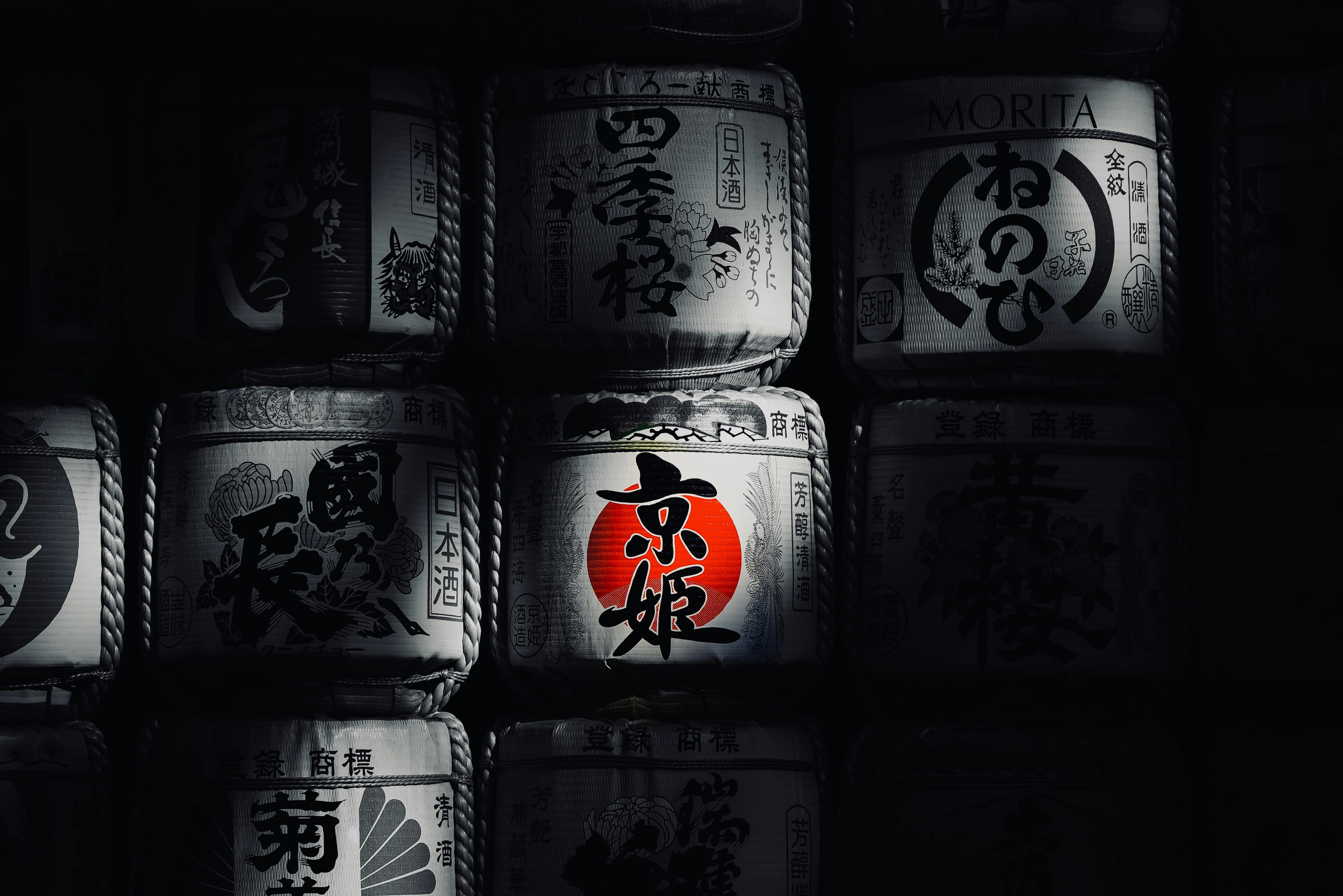 Stacked barrels with japanese calligraphy symbols and red circular symbol