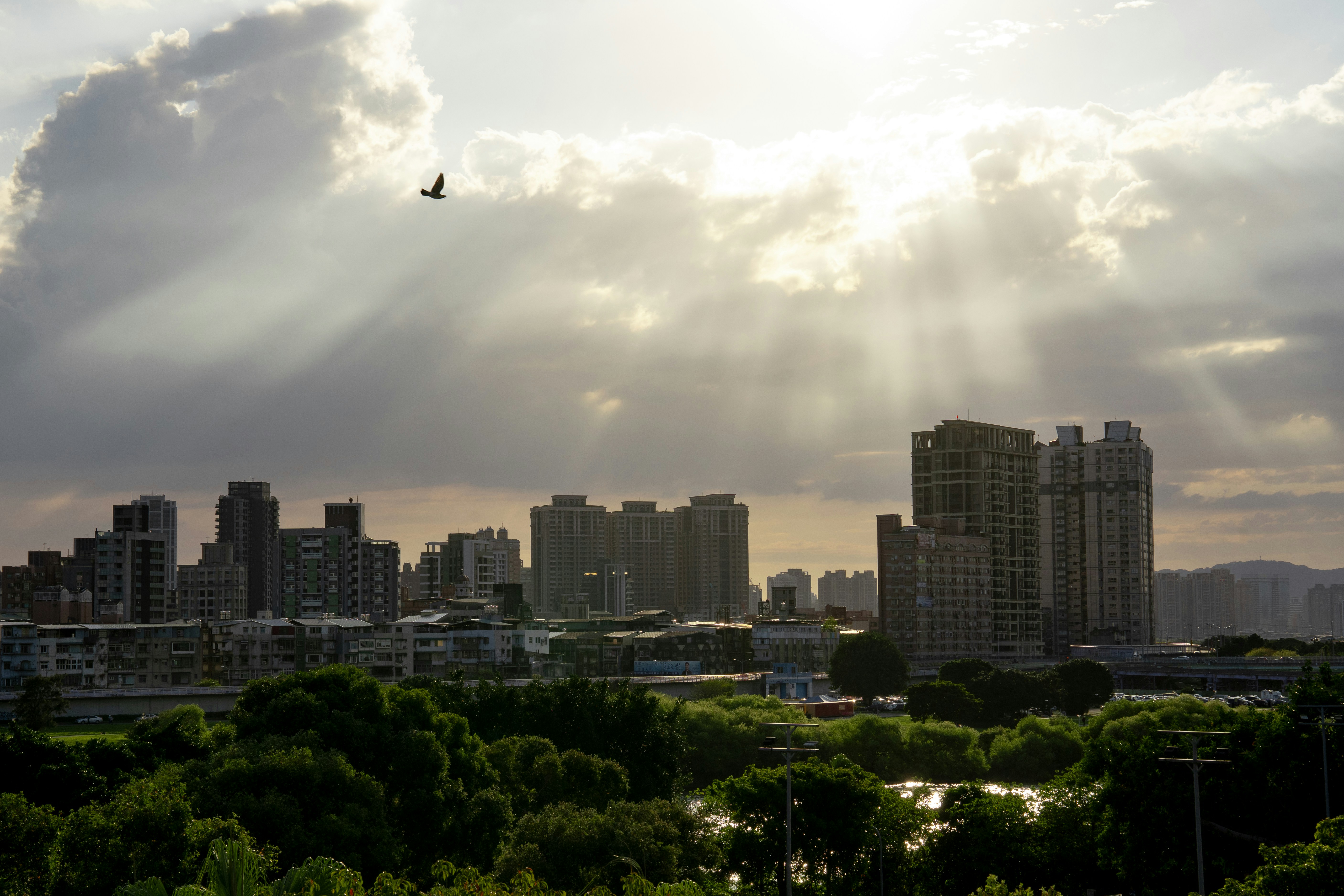 Sunlight streams through clouds over cityscape and cityscape.