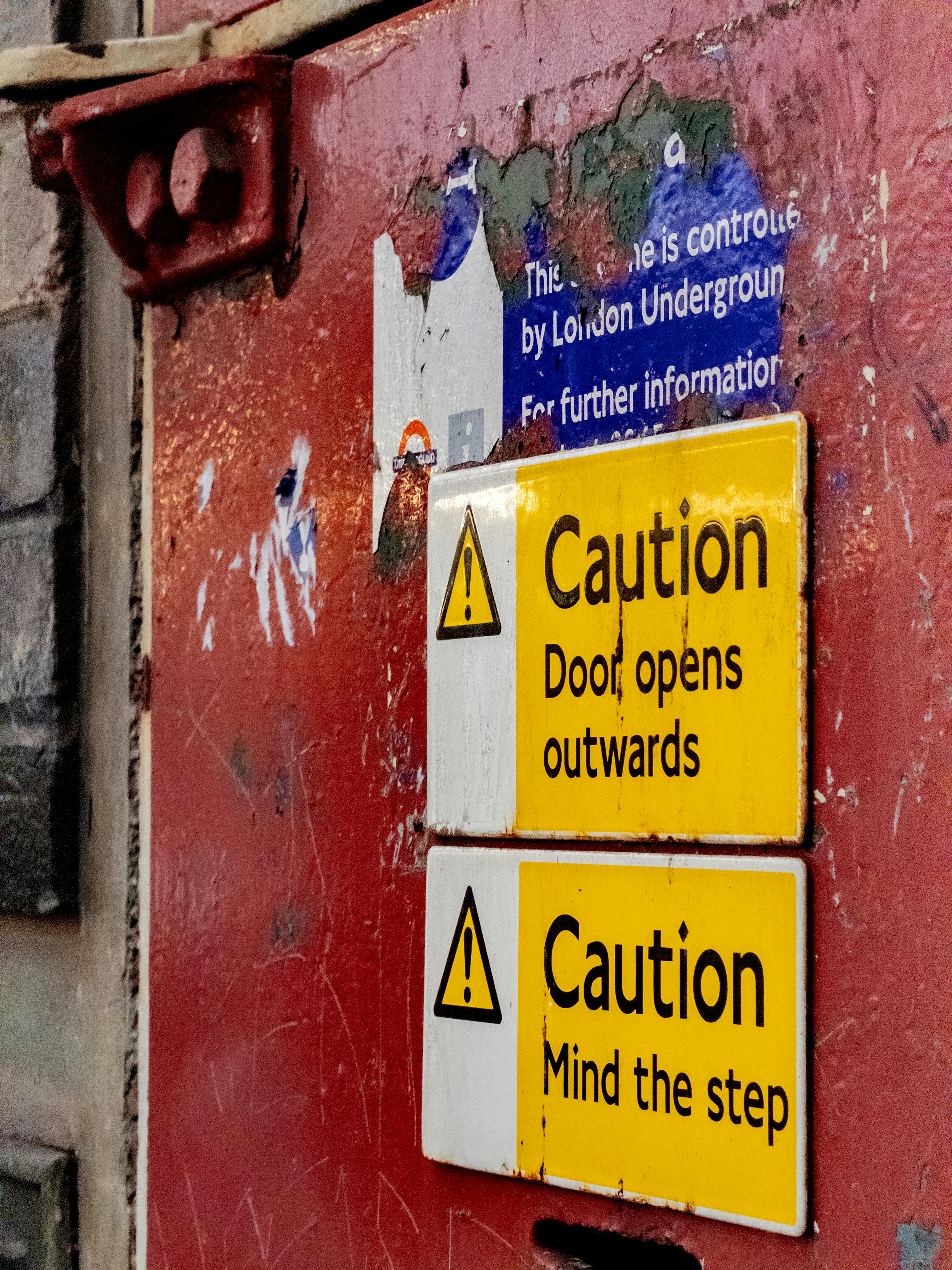 Caution signs on a red door