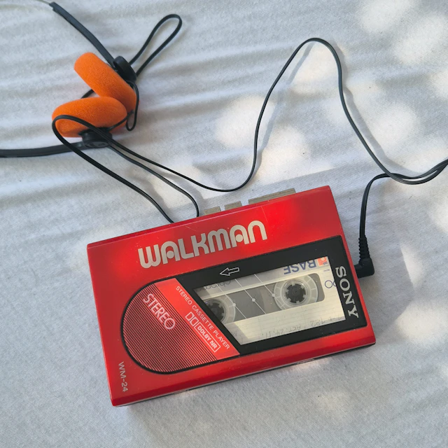Red Sony Walkman cassette player with orange foam on-ear headphones